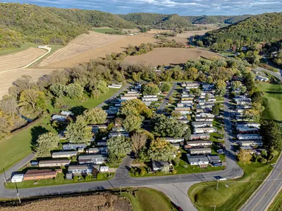 Aerial view of a mobile home park in a green valley